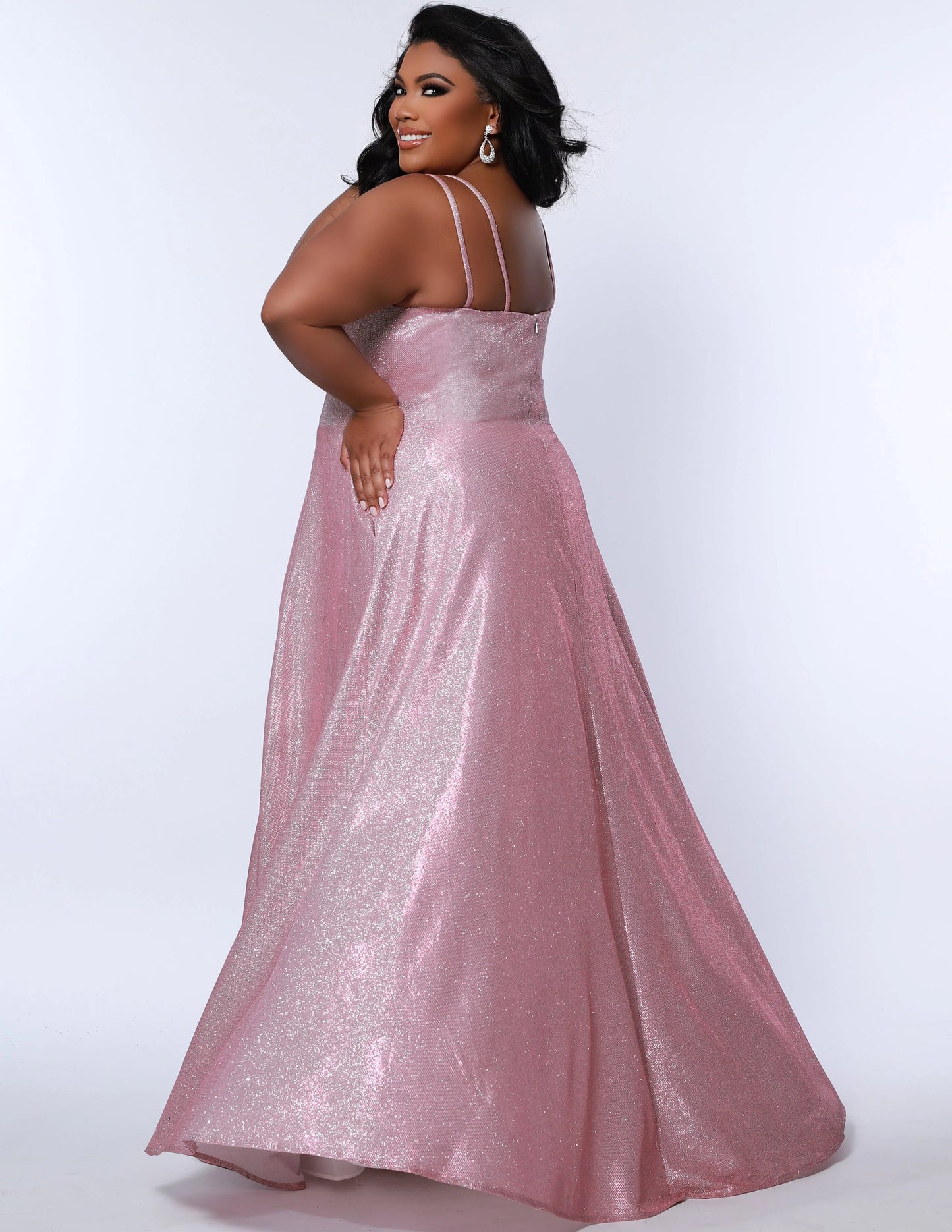 This plus-sized prom dress from Sydney's Closet SC7349 is made of shimmering knit and features an A-line silhouette, scoop neckline, double straps, zip-up back, natural waist, A-line skirt with slit, and hidden pockets. Fully lined for a comfortable and flattering fit. Perfect for special occasions. Keep it sweet and sparkly when you wear our classic A-line plus size prom dress! 
