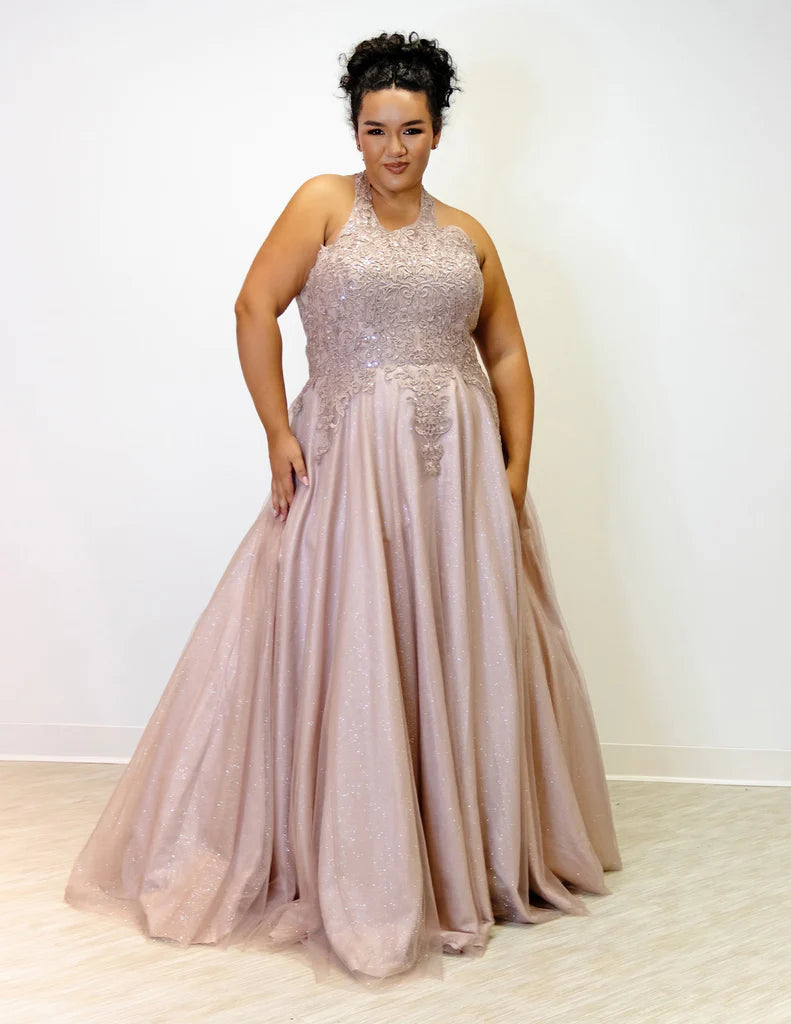 Sydney's Closet SC7352 A-Line Glitter Tulle Lace Appliques Lace Up Back Halter Neckline Plus Size Prom Dress. The Sydney's Closet SC7352 A-Line Glitter Tulle Lace Appliques Plus Size Prom Dress makes a glamorous addition to your wardrobe. This chic dress features an A-line silhouette, glitter tulle overlay, and delicate lace appliques - all crafted with an adjustable lace-up back and halter neckline. An elegant choice for formal occasions.