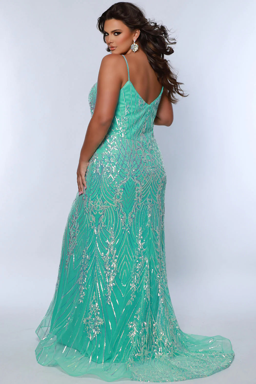 Look beautiful and timeless in this Sydneys Closet SC7366 Long Prom Dress. The fitted plus size gown is embellished with dazzling sequins and a graceful train. Perfect for your next formal event, this elegant dress is sure to make you the bright star of the night. Look glamorous on your big night in this sexy fitted Trumpet gown.