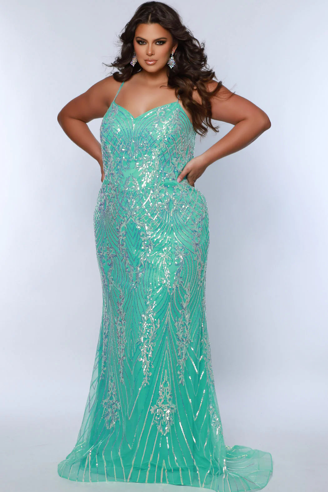 Look beautiful and timeless in this Sydneys Closet SC7366 Long Prom Dress. The fitted plus size gown is embellished with dazzling sequins and a graceful train. Perfect for your next formal event, this elegant dress is sure to make you the bright star of the night. Look glamorous on your big night in this sexy fitted Trumpet gown.