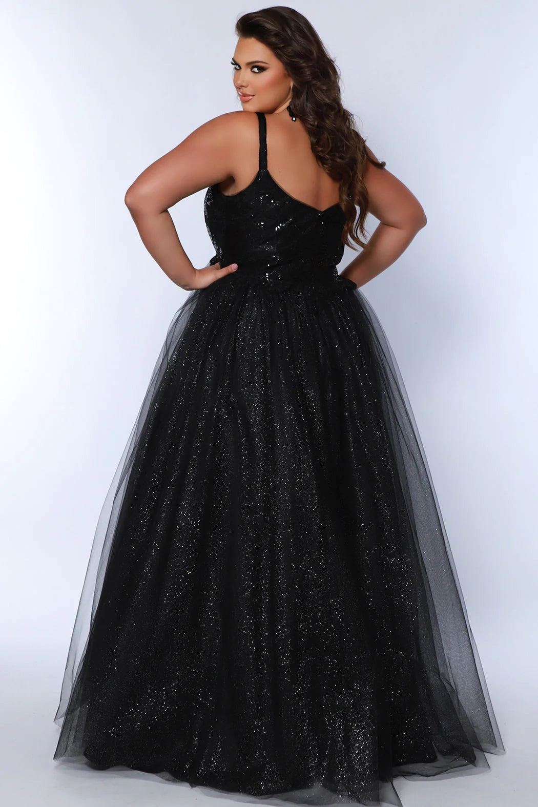 This plus-size evening gown from Sydneys Closet features a glamorous sequin-encrusted bodice, a V-neckline, and an A-line skirt for a modern, flattering silhouette. Crafted from luxurious fabrics, this formal gown is perfect for special occasions. 