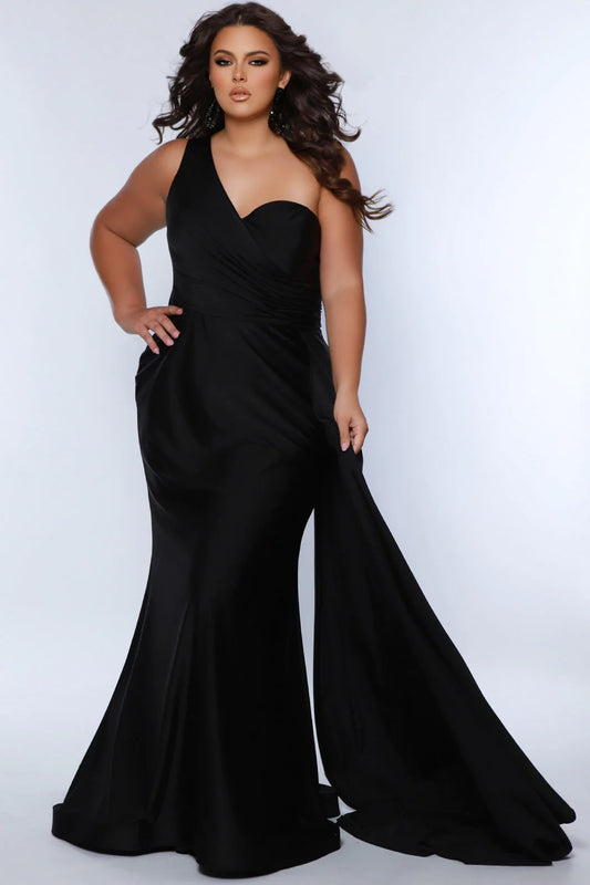 Experience elegance and glamour in the SC7377 gown from Sydneys Closet. This A-line over skirt dress features a one shoulder strap, perfect for your next special event or formal occasion. The full train adds a beautiful and regal finish to the look. Plus size available for up to size 24. Get ready to be the woman who turns heads at Prom 2024 or any special occasion evening event in the Simple and Sophisticated formal dress designed by Sydney's Closet.