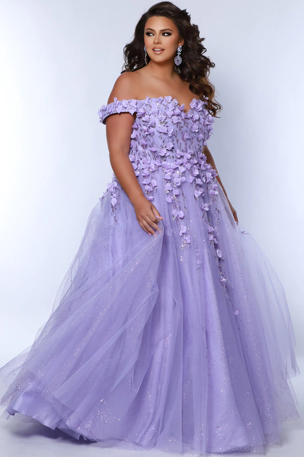 This glamorous Sydneys Closets SC7379 prom dress features an off-shoulder, sweetheart neckline and a fitted silhouette adorned with 3D floral details. The elegant design is perfect for a formal occasion such as a prom, pageant, or wedding. Plus size options are available for an ideal fit. Look and feel  like royalty at Prom 2024 or any formal ball when you opt to be lady who wears our "Dream On" gown.