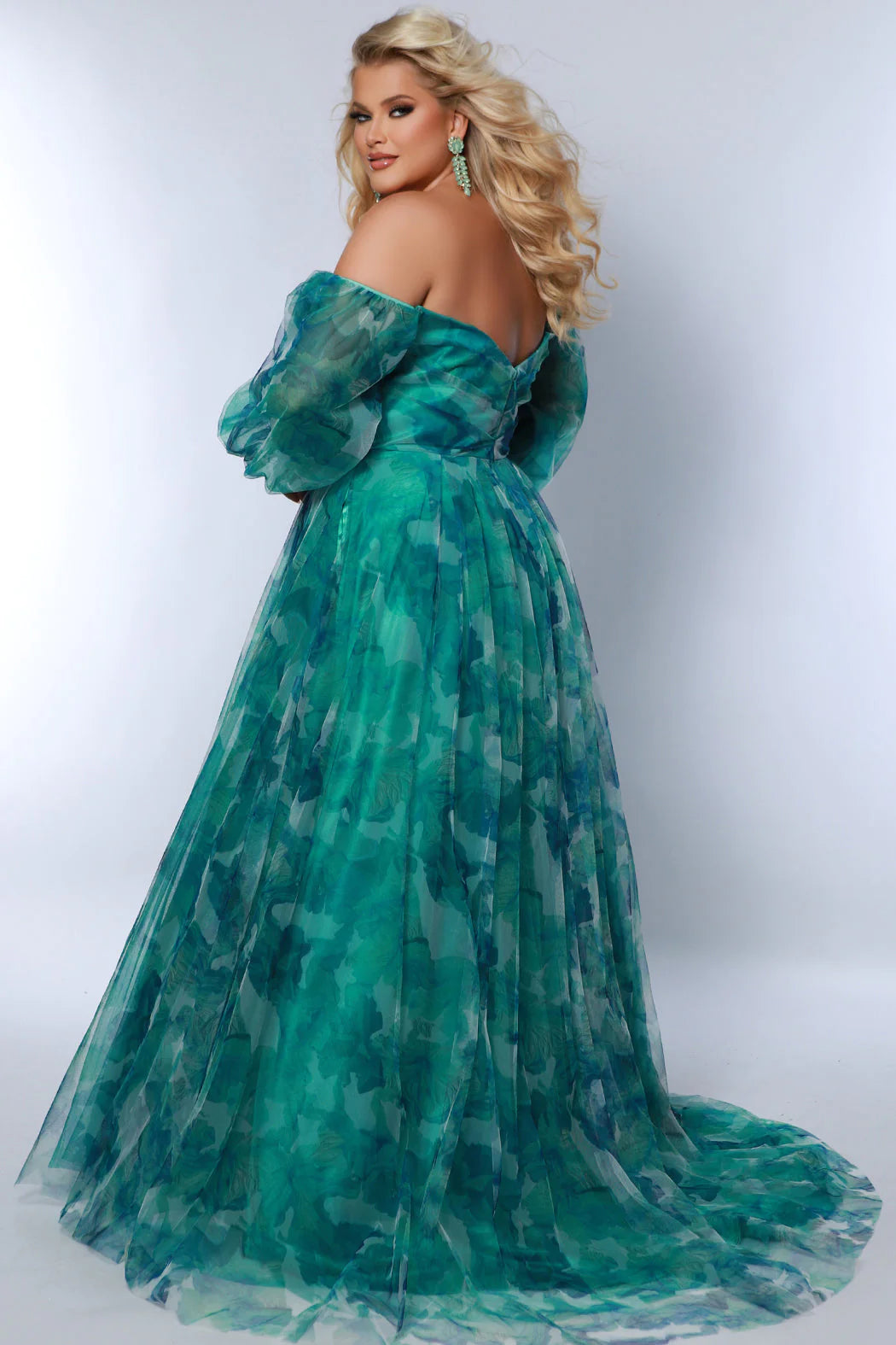 Elevate your special occasion look with this stunning Sydneys Closet SC7386 gown. Crafted with a beautiful A-line silhouette, this plus-size dress features floral digital print, alluring slit optional puff sleeves, pockets and a train. From prom to formal events, you will look and feel glamorous. Look like a breath of fresh air hen you wear our floral plus size maxi dress as a wedding guest or to any fancy formal event. 