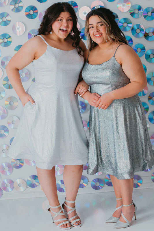 Sydney's Closet SC8118 A-Line Scoop Neck Spaghetti Strap Pockets Holographic Fabric Short Plus Size Homecoming Dress. Be the star of the night in Sydney's Closet SC8118 A-Line Scoop Neck Holographic Dress! With its eye-catching, sparkling fabric and plenty of pockets, you'll shine like a diamond and have plenty of room to carry all your essentials. Show off your curves in this sassy, short plus size homecoming dress and strut your stuff! Who says being a star is hard work?