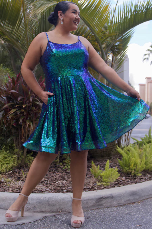 Sydney's Closet SC8122 A-Line Multi-Dimensional Sequins Scoop Neck With Pockets Short Plus Size Homecoming Dress. Make your homecoming night unforgettable with this plus size showstopper! Sydney's Closet SC8122 dress features a dazzling multi-dimensional sequin exterior, scoop neckline, and front pockets to keep your dancing essentials close at hand. A glam-slam pick that will leave you feeling your 'prom