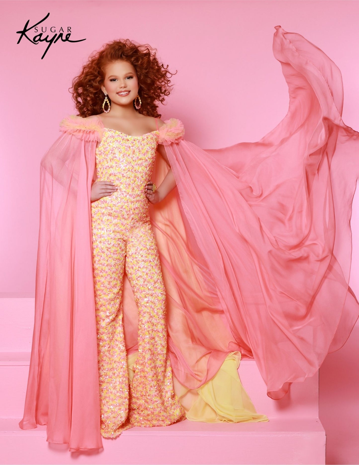 The Sugar Kayne C341 Jumpsuit is the perfect choice for your little princess. This fashionable, comfortable outfit features an all-over sequin design, ruffle sleeves and matching cape for a unique look. Perfect for clinics, pageants and any special occasion. Experience the shimmer sensation in our Sequin Power mesh Jumpsuit and matching cape! The sequined brilliance and ruffles on the shoulders create a look that's enchanting and show-stopping!