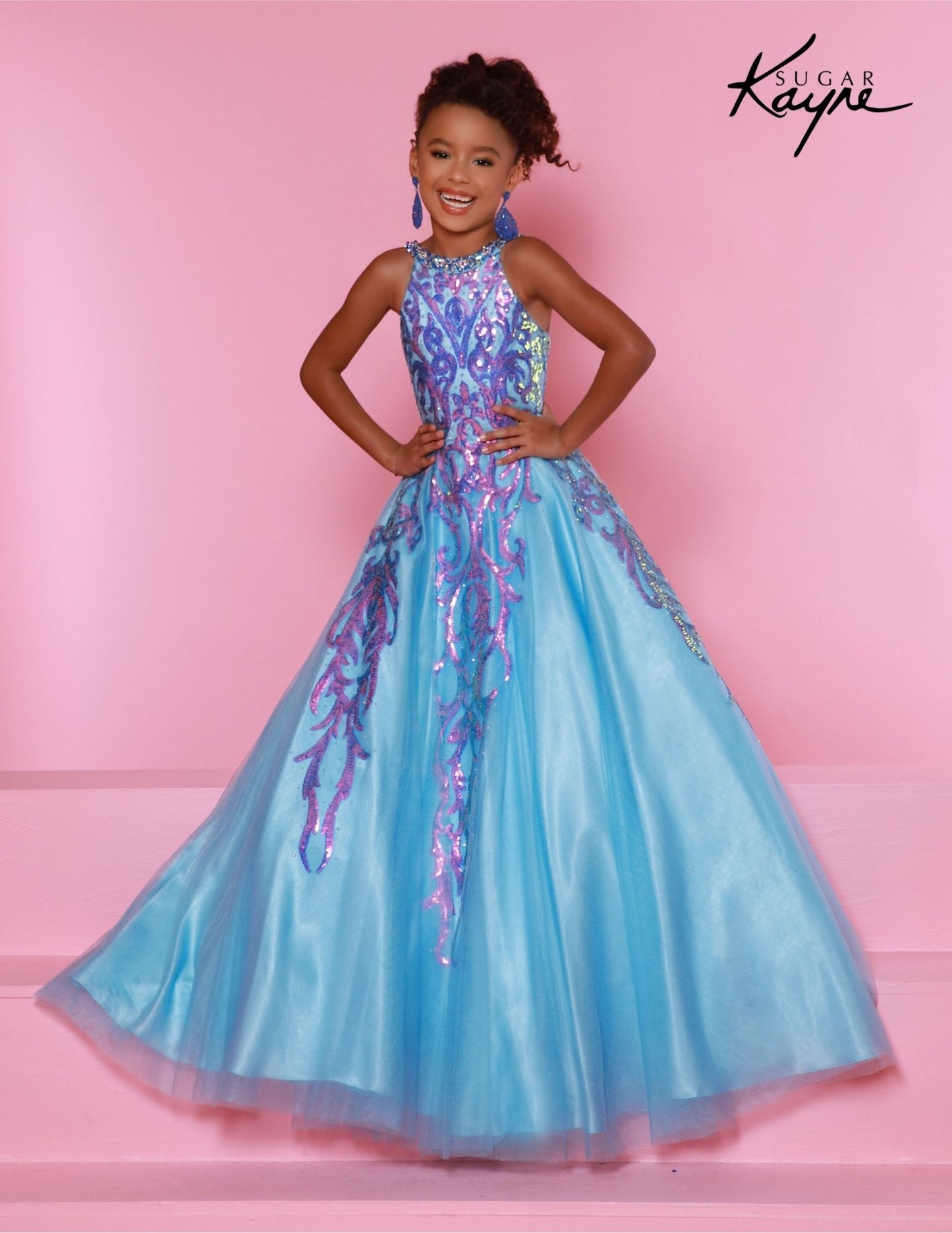 This Sugar Kayne C344 Preteen Pageant Dress is the perfect choice for any special occasion. The dress features a halter neckline, a glittering sequin bodice, and an A-line skirt. Its classic design and streamlined silhouette bring a timeless elegance to any event.&nbsp;Glittering Grace! This Sequin Mesh Ballgown and halter-style neckline ensure you will captivate the audience with grace and style!

Color:&nbsp;Jade, Magenta, Sky Blue

Size:&nbsp;2, 4, 6, 8, 10, 12, 14, 16

Fabric:&nbsp;Mesh, Sequin Mesh, Sa