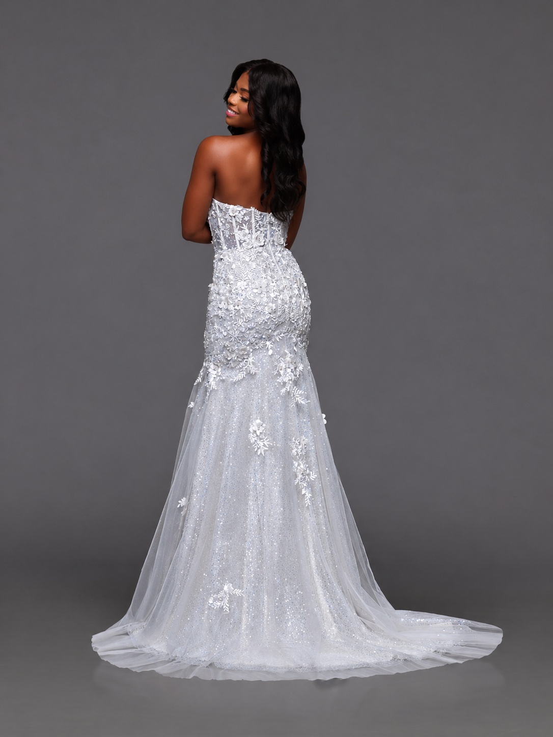 Stunning white lace prom dress by Candice Wang featuring an elegant mermaid silhouette. This show-stopping gown showcases a sheer sequin corset bodice with a daring plunging neckline that commands attention. The intricate lace detailing and fitted mermaid cut create a glamorous, sophisticated look perfect for prom night. Make an unforgettable entrance in this breathtaking formal wear.

Size: 2

Color: White