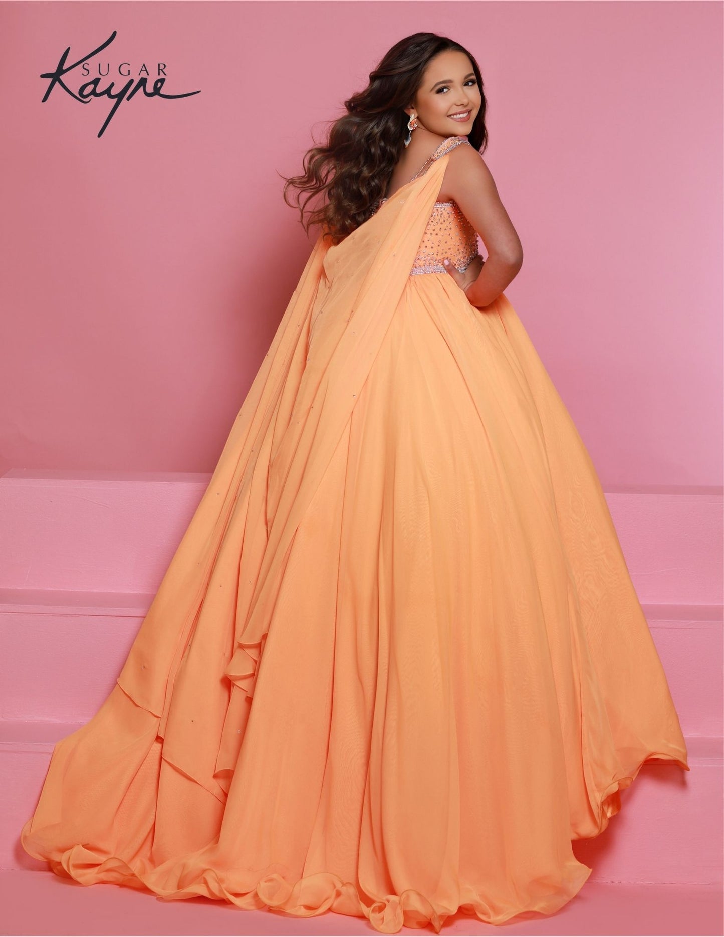 Sugar Kayne C329 Tangerine Pageant Dress features a chiffon skirt, semi sweetheart neckline encrusted with rhinestones and wide straps with a cape. back