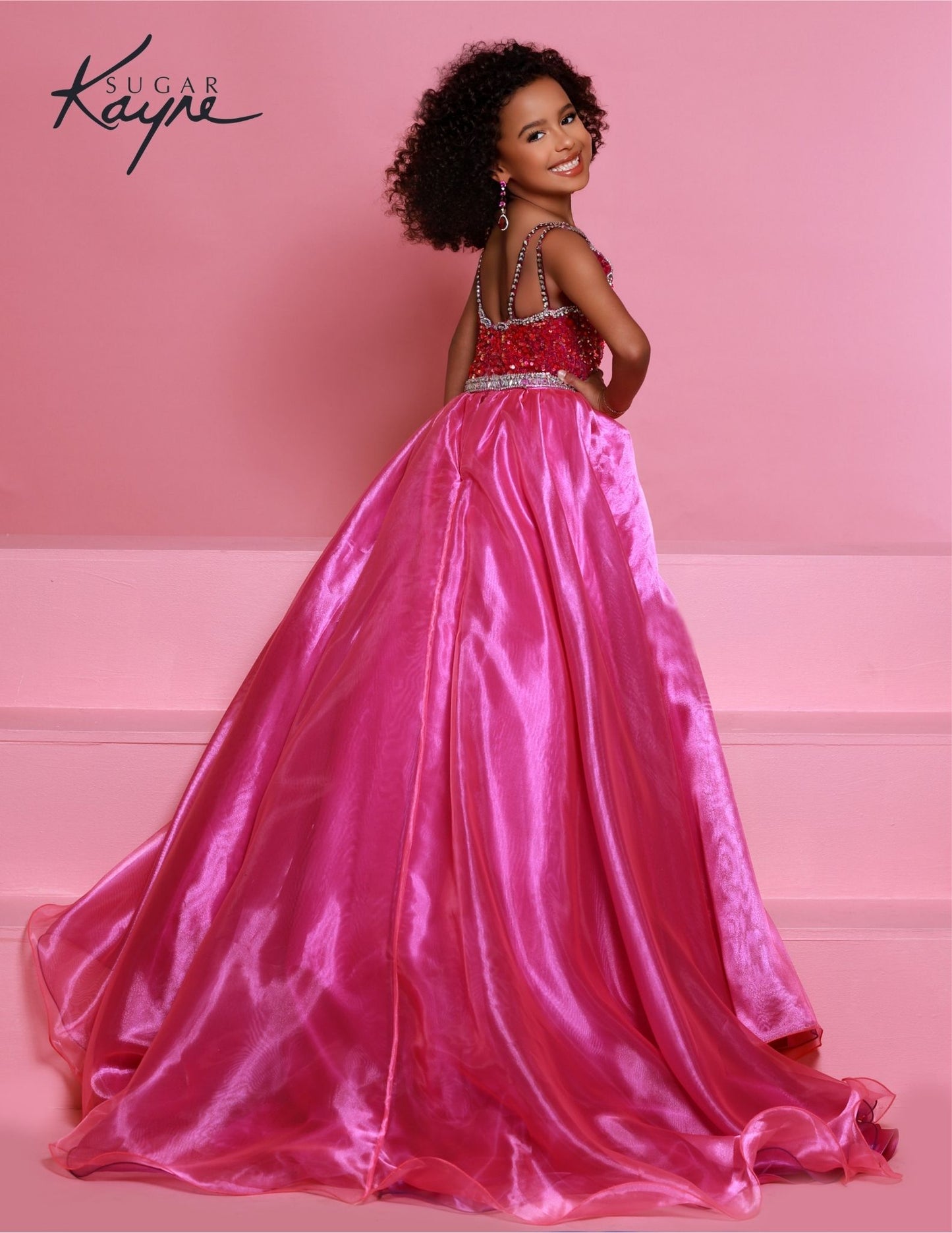 Sugar Kayne C332 offers a unique sequined jumpsuit style for girls and preteens with its fun fashion detachable overskirt and halter neckline on magenta stretch sequin velvet. 