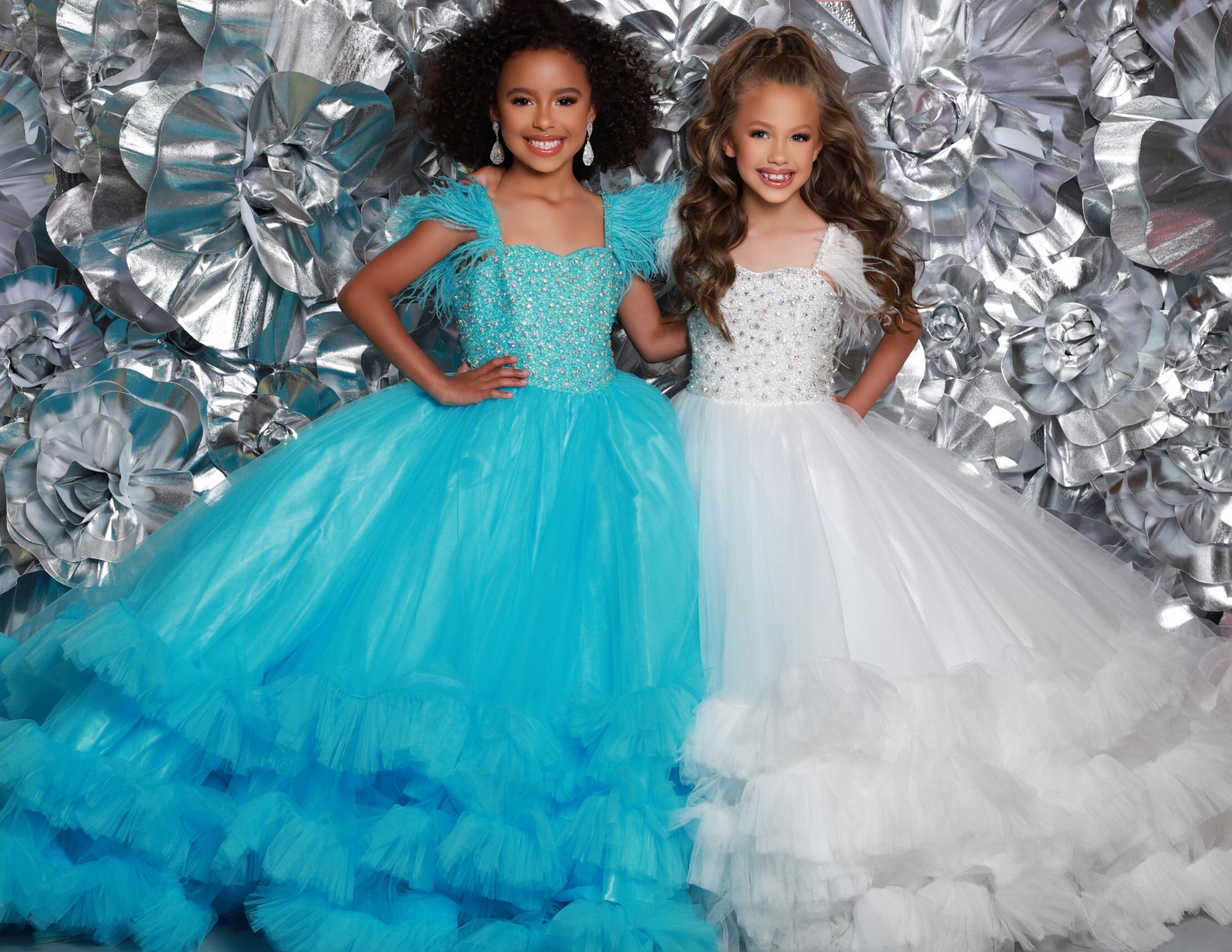 Sugar Kayne C327 features a fashionable pageant dress for girls and preteens, complete with feather straps, a tiered ruffle bottom, and a crystal stone bodice.&nbsp;Stand out and feel confident on stage! This tulle ballgown features ostrich feathers on the shoulders, a beaded bodice, and tiered skirt to show off your personality!

Colors:&nbsp; Aqua, Bubblegum, White, Magenta

Sizes:&nbsp;&nbsp;2, 4, 6, 8, 10, 12, 14, 16

(Sizes 2-6 do not have bust cups, Sizes 8-16 will have preteen size bust cups)