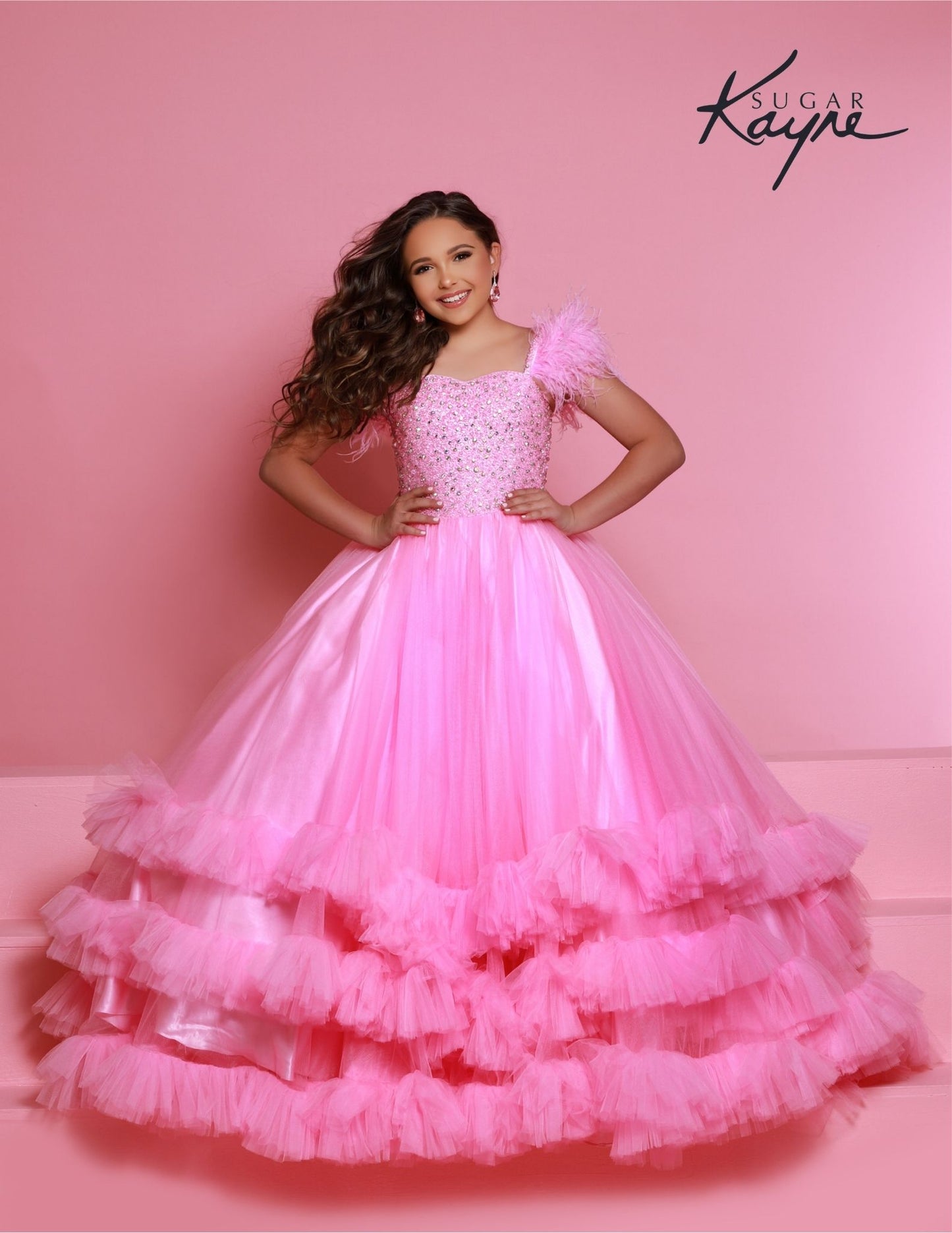 Sugar Kayne C327 features a fashionable pageant dress for girls and preteens, complete with feather straps, a tiered ruffle bottom, and a crystal stone bodice.&nbsp;Stand out and feel confident on stage! This tulle ballgown features ostrich feathers on the shoulders, a beaded bodice, and tiered skirt to show off your personality!

Colors:&nbsp; Aqua, Bubblegum, White, Magenta

Sizes:&nbsp;&nbsp;2, 4, 6, 8, 10, 12, 14, 16

(Sizes 2-6 do not have bust cups, Sizes 8-16 will have preteen size bust cups)