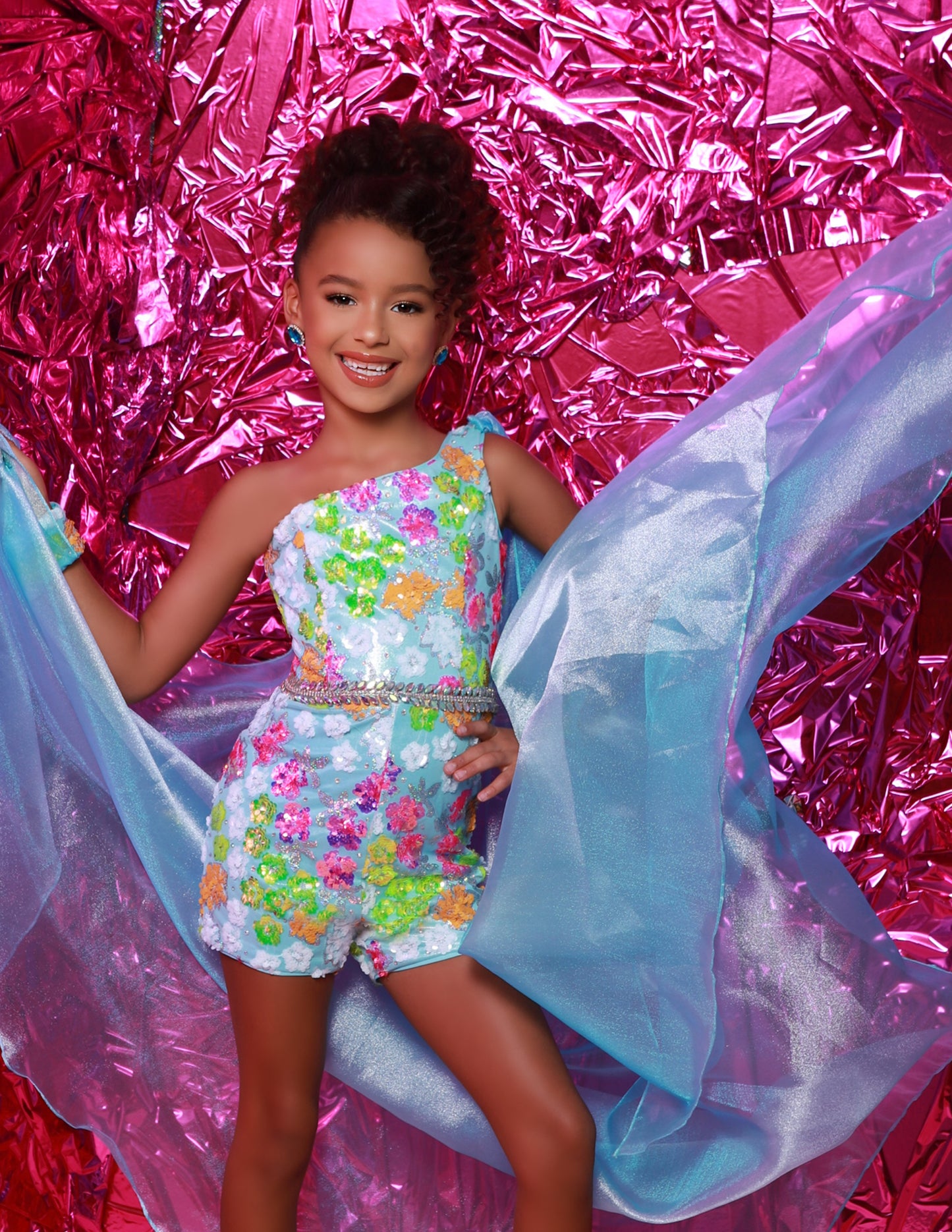 The Sugar Kayne C347 is a fun, fashion shimmer girls pageant romper with a sequins mesh overskirt. It's designed with soft and comfortable material, perfect for any special occasion.&nbsp;Shine bright on stage with our Sequin Mesh Romper and Shimmer Organza Overskirt! This romper is designed for those girls who love to sparkle and own the stage!

Color:&nbsp;Bluetiful, Lemon Burst

Size:&nbsp;2, 4, 6, 8, 10, 12, 14, 16

Fabric:&nbsp;Sequin Stretch Mesh, Metallic Jersey Lining, Shimmer Organza

(Sizes 2-6 do