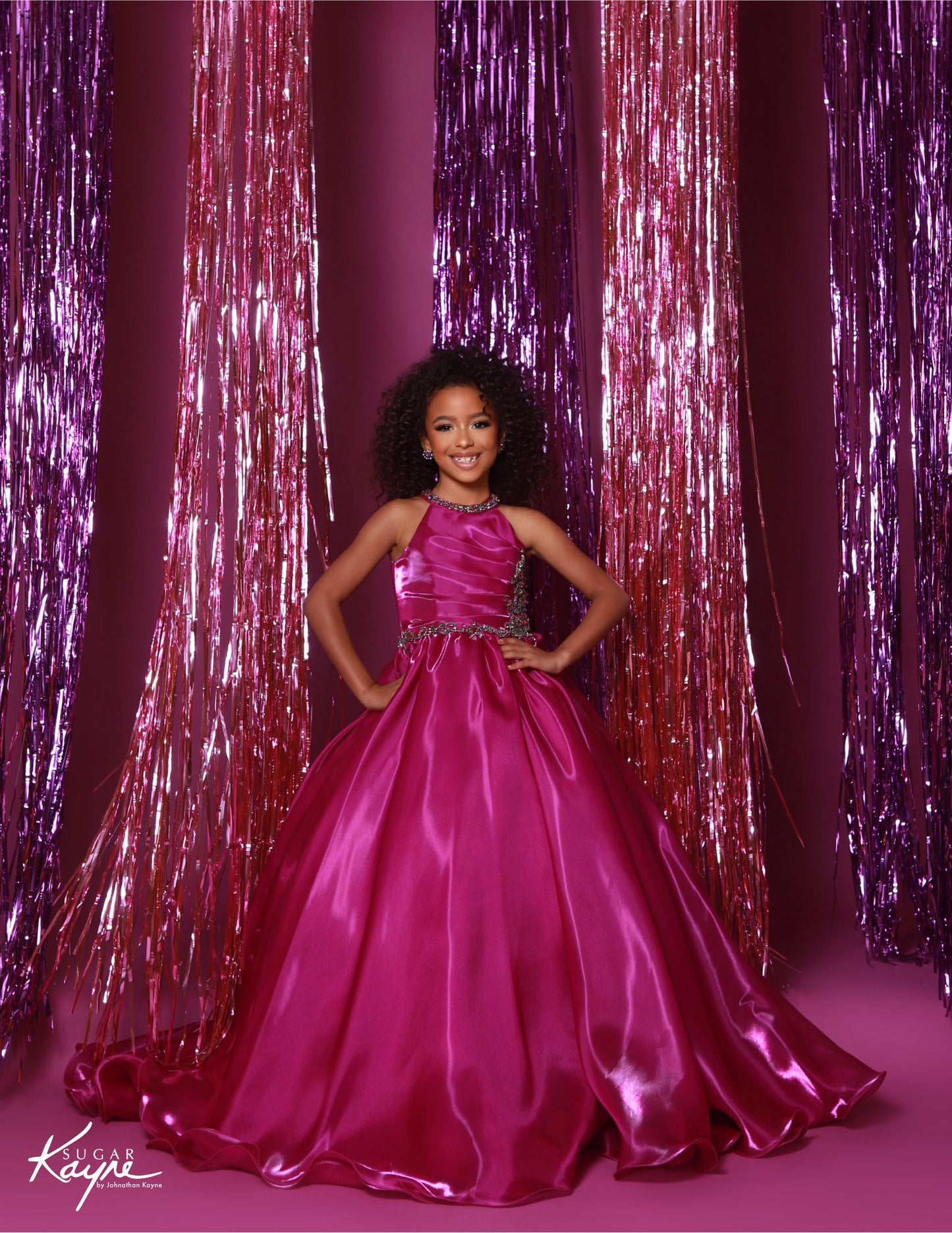 This stunning Sugar Kayne C379 pageant dress features a high neck and A-line design with shimmering beaded details. The elegant ballgown silhouette is perfect for any formal event, ensuring your little girl looks and feels like a princess. Make a statement with this beautiful and eye-catching dress. Step into the spotlight and embody the dazzling diva within! This mirror organza ballgown, with its elegant halter-style neckline, guarantees you’ll captivate the audience with both grace and style.&nbsp;

Sizes