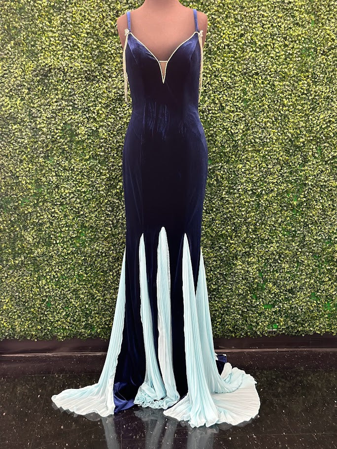 This Johnathan Kayne 2706 gown features a long fitted velvet silhouette with a pleated mermaid skirt and elegant train, designed to enhance your figure with sophisticated flair. The off-the-shoulder sleeves are adorned with a detachable crystal fringe tassel, adding a touch of sparkle and versatility. Perfect for pageants or formal events, This velvet dress combines classic elegance with modern detailing for a standout look.

Size: 4

Color: Navy/Aqua