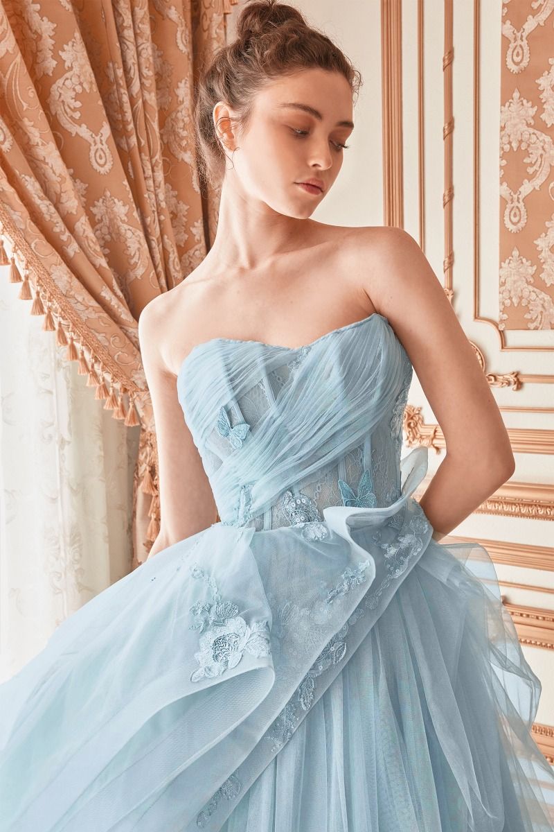 Experience couture luxury in Andrea & Leo Couture's A1021 Sheer Layered Ballgown. Combining a corset bodice with a sheer layered skirt, this fairytale gown is the ideal formal dress for any special occasion. Sophisticated and elegant, the gown is made of quality materials and comes in a variety of sizes. Look no further than this breath-taking strapless layered tulle ball gown! 