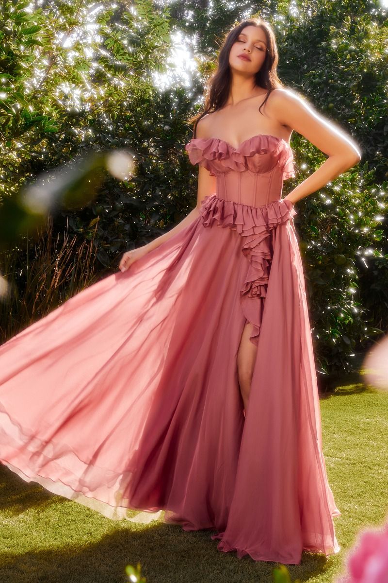 The Andrea & Leo Couture A1341 is a stunning chiffon formal dress that features elegant ruffles and a sheer corset design. The maxi length offers a flowy and sophisticated look, while the slit adds a touch of sensuality. Perfect for bridesmaids or any formal occasion. Dance through dreams in our strapless A-line chiffon dress—a romantic reverie crafted for the heart's delight. The sweetheart neckline, adorned with whimsical ruffles, frames the décolletage in a cascade of enchantment. 