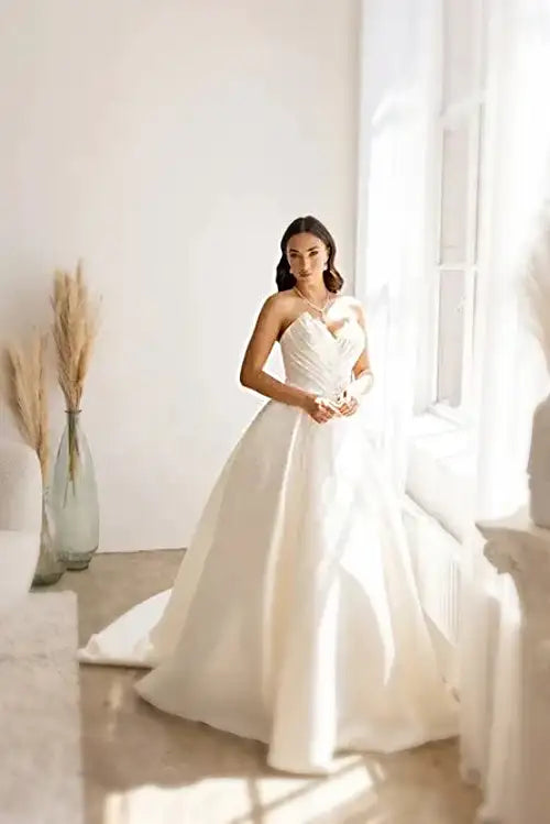 Look mesmerizing on your special day in the Abby Lane Bridal 97179 Ivory Satin Ballgown Wedding Dress. This strapless gown features a ruched bodice and neckline to flatter any figure. Crafted from soft satin, it will be a beautiful and comfortable choice.