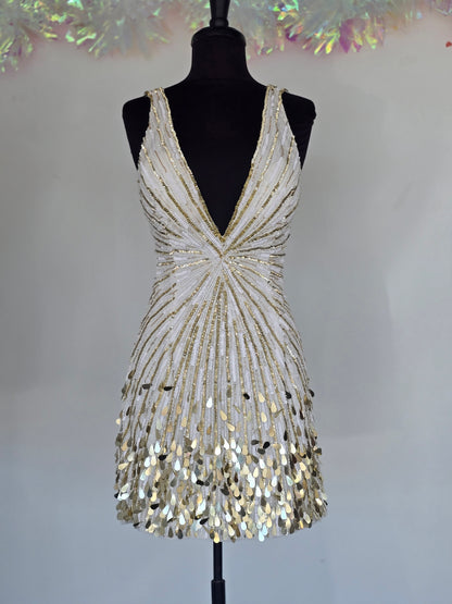 Step into the spotlight with the Primavera Couture 4417, a short backless cocktail gown designed to dazzle. Featuring a flattering V-neck and shimmering sequins, this homecoming dress combines elegance with a playful edge. Its backless design adds a touch of allure, perfect for making unforgettable memories at your special event. Comfortable and stylish, it’s crafted to help you feel confident and radiant all night long.

Sizes: 6

Colors: Ivory/Gold
