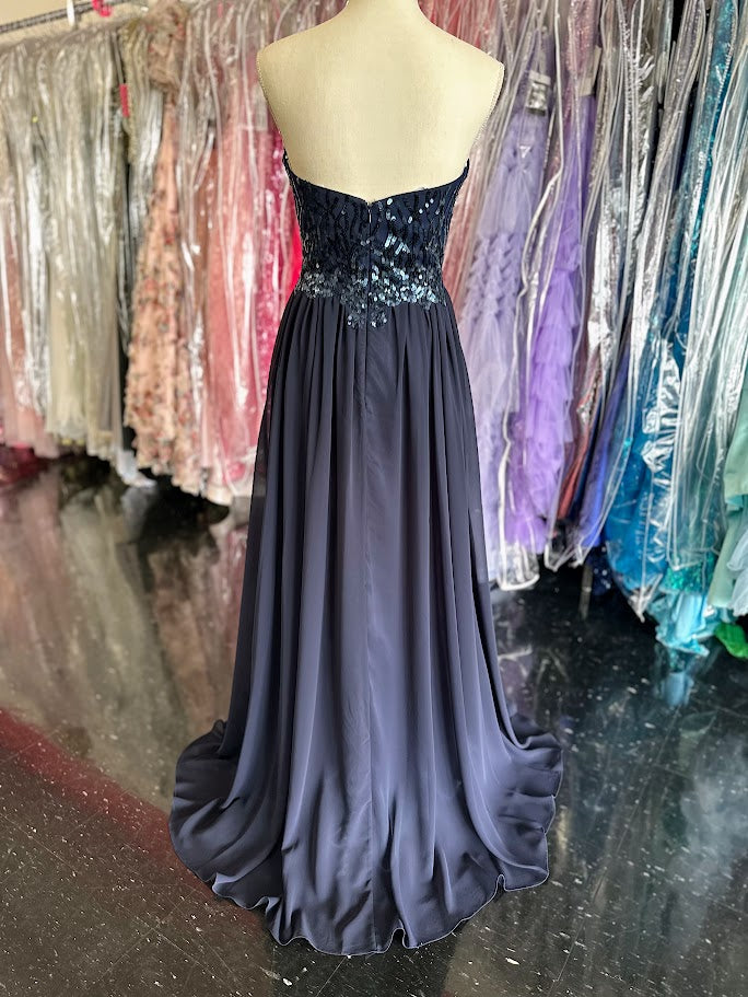 The Envious Couture BM196 in a Size 8 features a sophisticated navy chiffon fabric that flows beautifully in an A-line silhouette, ideal for bridesmaids and formal occasions. Adorned with subtle sequins, this long dress adds a refined sparkle without overwhelming the design. Its breathable chiffon ensures comfort throughout your event, while the classic cut flatters various body types, making it a reliable and stylish choice for any formal celebration.

Size: 8

Color: Navy