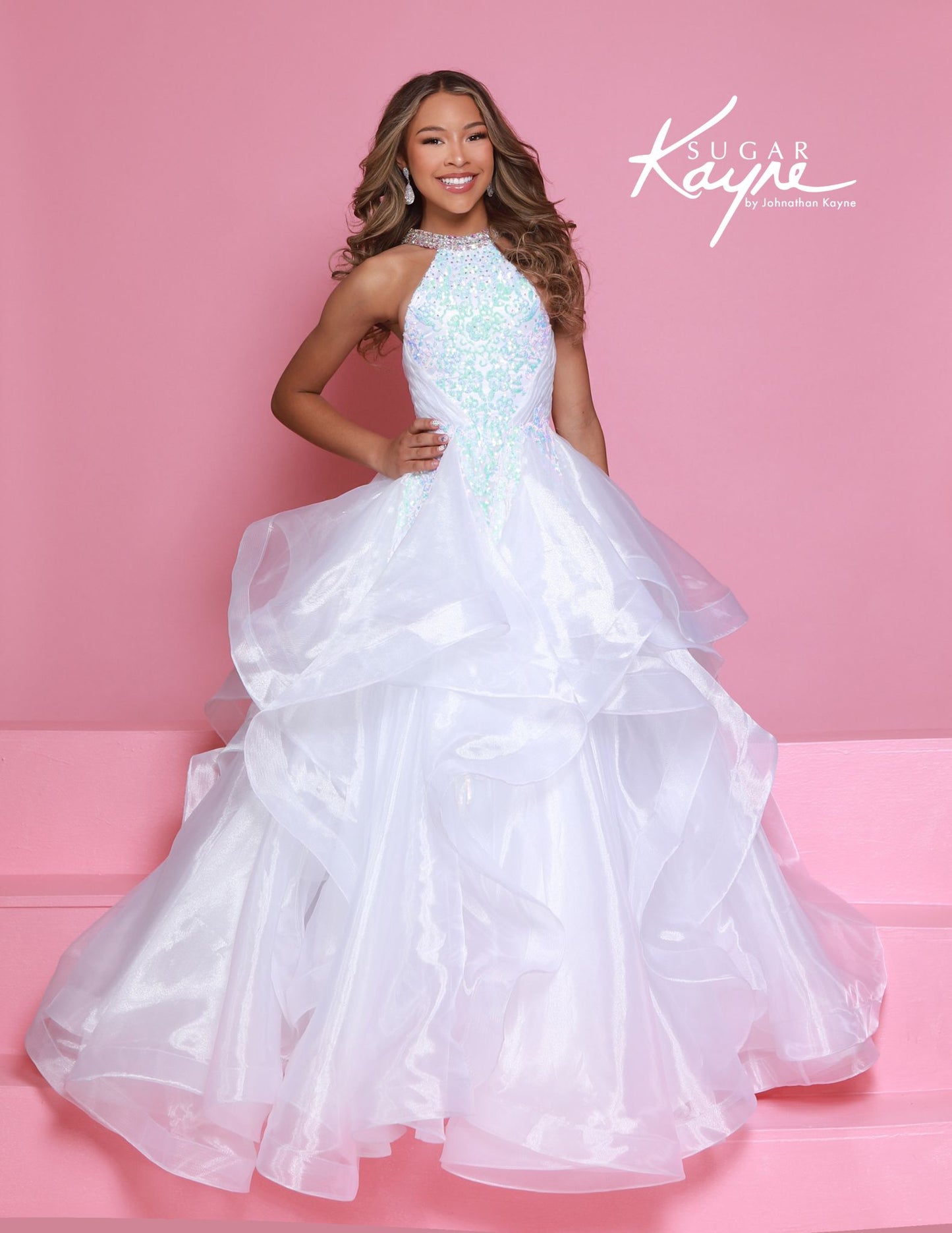 Dress to impress in the Sugar Kayne C371 Pageant Dress. This stunning A-line ballgown features sequin and ruffle details, a high neck, and layered skirt. Perfect for any pageant, this dress will make you stand out from the competition with its elegant and eye-catching design. Elevate your pageant game with Sugar Kayne. Embody elegance and glamour with this dazzling sequin mesh ballgown, designed to make you sparkle on stage. Featuring a halter neck with shimmering beading that highlights your neckline, and 