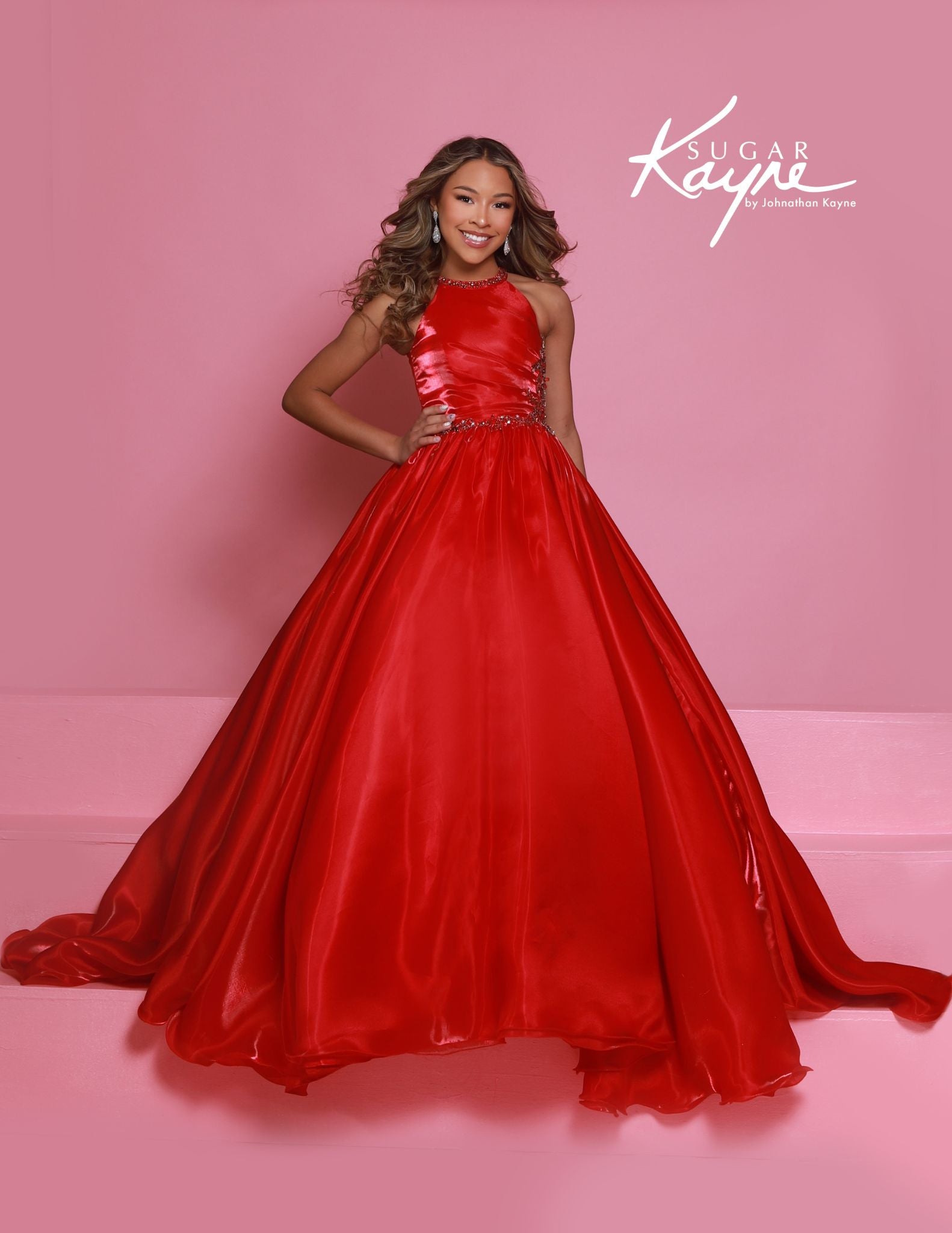 This stunning Sugar Kayne C379 pageant dress features a high neck and A-line design with shimmering beaded details. The elegant ballgown silhouette is perfect for any formal event, ensuring your little girl looks and feels like a princess. Make a statement with this beautiful and eye-catching dress. Step into the spotlight and embody the dazzling diva within! This mirror organza ballgown, with its elegant halter-style neckline, guarantees you’ll captivate the audience with both grace and style.&nbsp;

Sizes