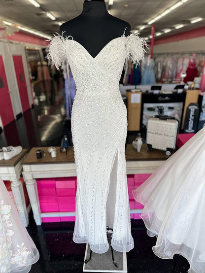 The Ladivine CD0207W Long Sequin Feather off the shoulder Slit Pageant Dress Prom Reception Gown is the perfect choice for prom night or a special occasion. Expertly designed with sequins and feathers, this dress features an off-the-shoulder bodice, a long silhouette and a side slit, making it both stylish and comfortable.&nbsp;Looking to make an unforgettable entrance at your next big event? Look no further then this gorgeous sequin gown. Crafted from sparkling fabric, the fitted silhouette emphasizes your