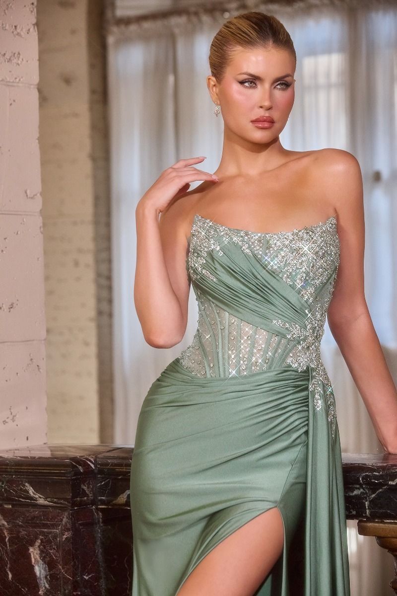 Elevate your prom night with the Ladivine CD689, a stunning beaded sheer corset gown designed to turn heads. This sophisticated dress features a delicate scoop neckline, intricate beading throughout the sheer corset bodice, and a dramatic backless design that exudes elegance. The flowing train and thigh-high slit add movement and allure to your silhouette. Perfect for those seeking a show-stopping formal look that balances glamour with modern edge, this gown promises an unforgettable entrance.

Silhouette:&