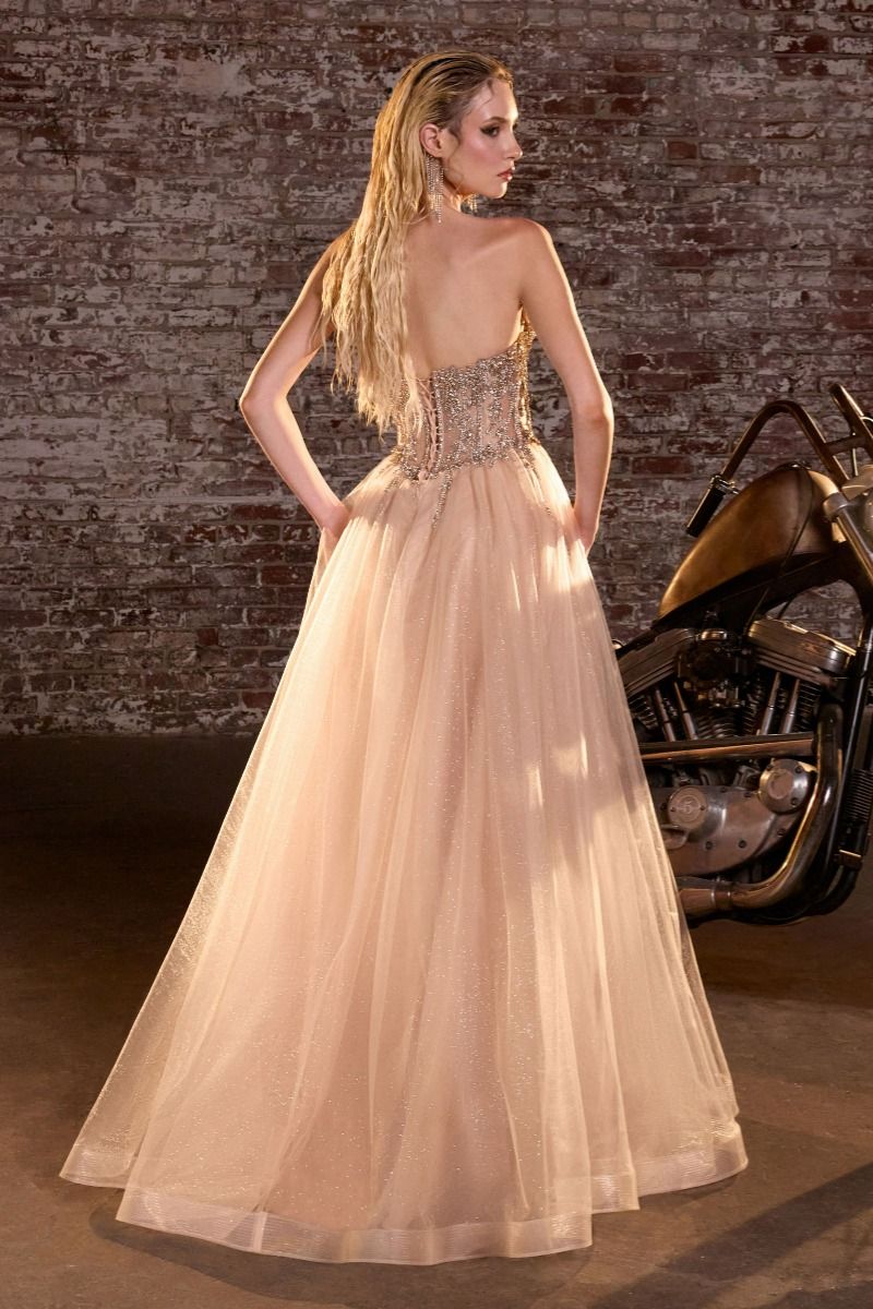 Elevate your prom night with the Ladivine CD721, a strapless A-line gown that commands attention. The plunging sweetheart neckline frames your silhouette beautifully, while intricate crystal embellishments adorn the corset bodice for a touch of glamour. The flowing skirt creates an elegant silhouette that moves gracefully across the dance floor, and the dramatic train adds a finishing flourish of sophistication. Perfect for those seeking a show-stopping formal look that balances modern edge with timeless el