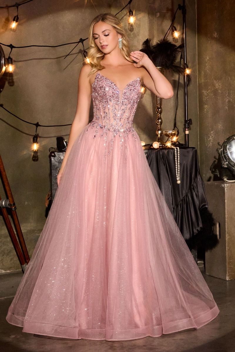 Elevate your prom night with the Ladivine CD721, a strapless A-line gown that commands attention. The plunging sweetheart neckline frames your silhouette beautifully, while intricate crystal embellishments adorn the corset bodice for a touch of glamour. The flowing skirt creates an elegant silhouette that moves gracefully across the dance floor, and the dramatic train adds a finishing flourish of sophistication. Perfect for those seeking a show-stopping formal look that balances modern edge with timeless el