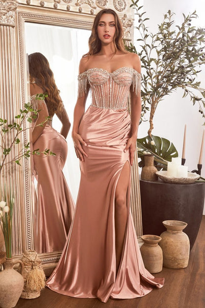 This Ladivine CD821 dress features a sheer off-the-shoulder corset, crystal embellishments, and a satin skirt with a flattering front slit and fringe detailing. Perfect for prom, pageants, or elegant evening events, this dress will make you feel sophisticated and glamorous