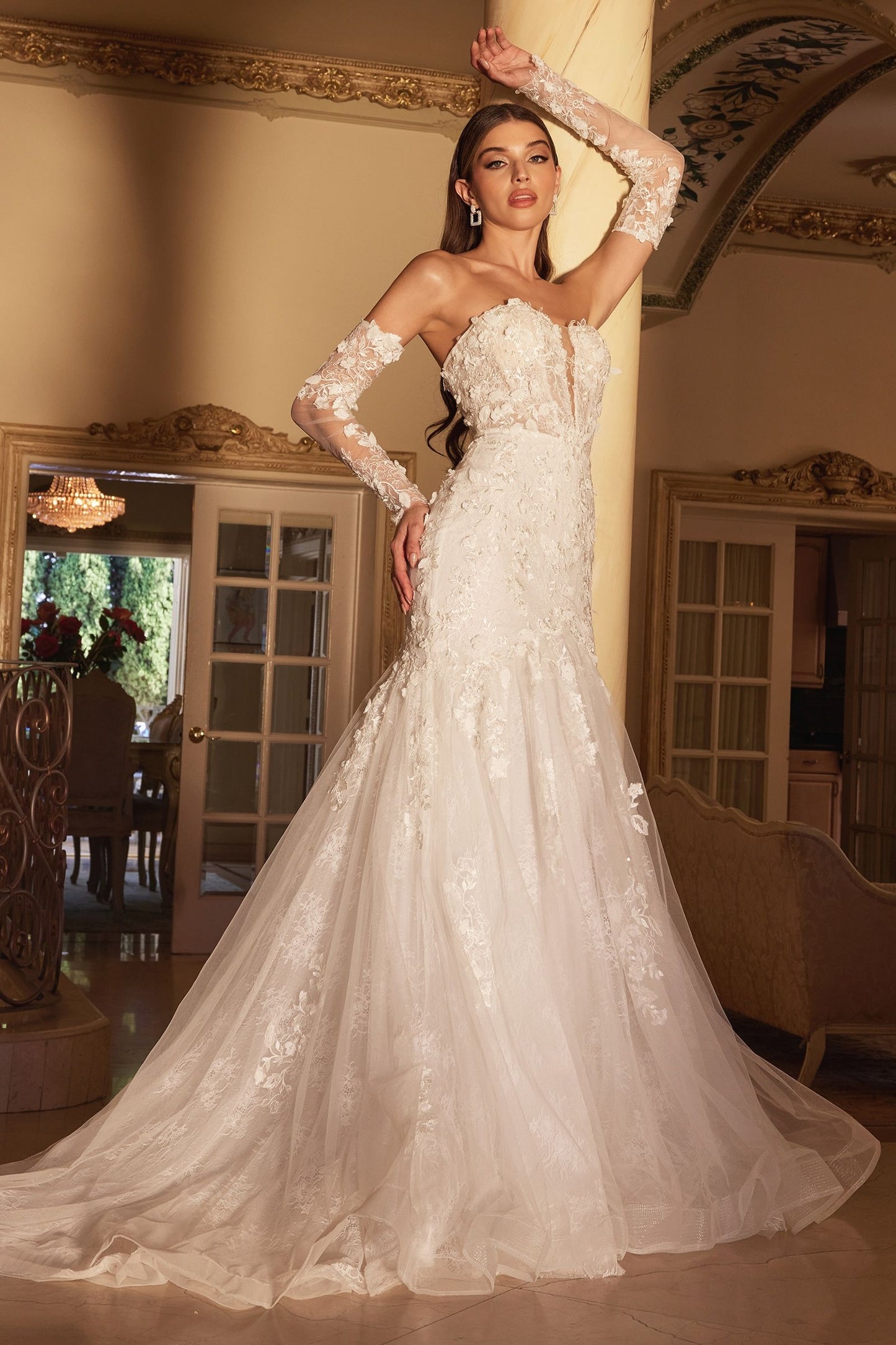 This Ladivine CD977W wedding dress features a beautiful chantilly lace design and three-dimensional floral appliques. The fit-and-flare silhouette includes a plunging v-neckline and lace-up corset back, with removable off-the-shoulder long lace sleeves and a detachable underarm for a customizable look. Perfect for making a lasting impression at your special event.