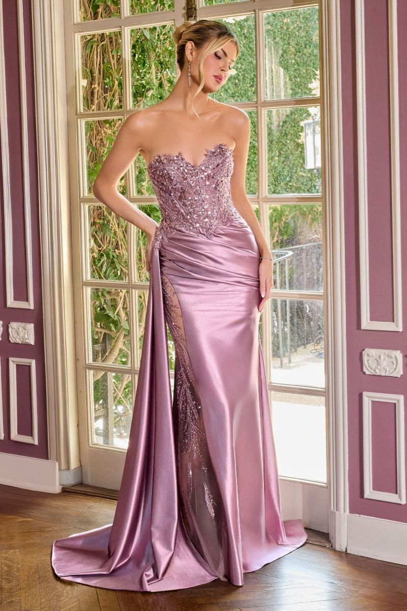 Elevate your prom night with the Ladivine CDS565, a stunning strapless gown designed to captivate. This exquisite dress features a sweetheart neckline and a sheer beaded corset bodice that creates an alluring silhouette. The intricate beadwork catches light beautifully, while the graceful train adds dramatic elegance as you move. Perfect for those seeking a show-stopping formal look that balances sophistication with glamour.

Silhouette:&nbsp;Fitted
Design:&nbsp;Sweetheart neckline, fully beaded bodice &amp