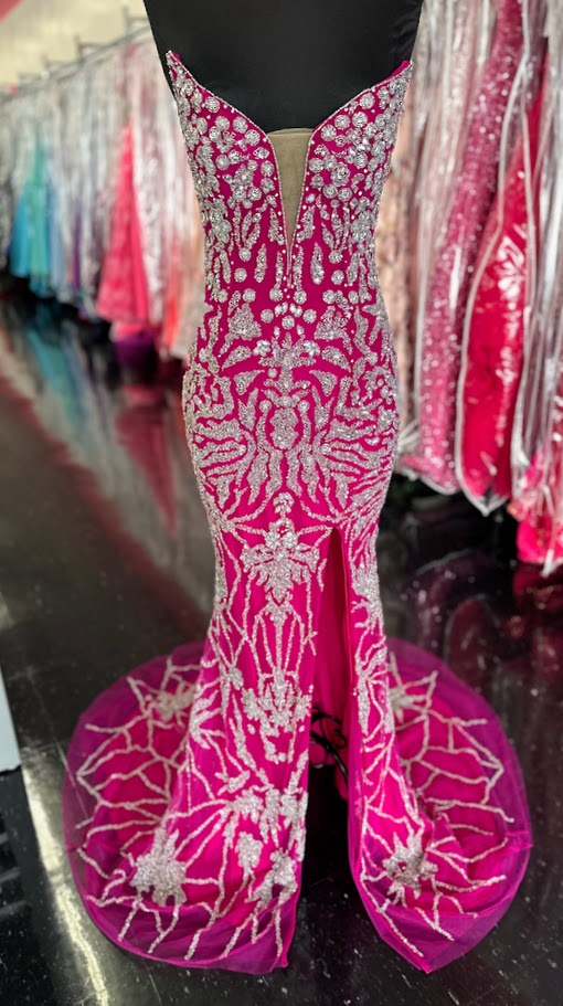 This elegant fuchsia evening gown from Chic and Holland features intricate beadwork that enhances its sophisticated appeal. Designed for formal occasions, the floor-length dress includes a tasteful slit, offering both movement and modern style. Tailored to a size 2, it delivers a flattering silhouette perfect for pageants or upscale events. The combination of refined detailing and vibrant color ensures a standout presence at any formal gathering.

Size: 2

Colors: Fuchsia
