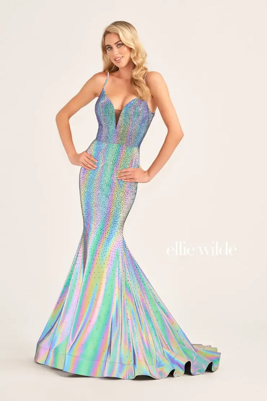 This show-stopping Ellie Wilde dress features a holographic Supernova fabric Fully crystal studded bodice with v neckline. The form-fitting long mermaid silhouette gives you a dramatic entrance that’s sure to leave a lasting impression. How does it work? The moment the camera flashes go on you will hear it across the room as you explode into a dazzling mix of color. The Supernova effect is created with special light reflective fabric that comes to life when direct light hits it in a darkened environment. 