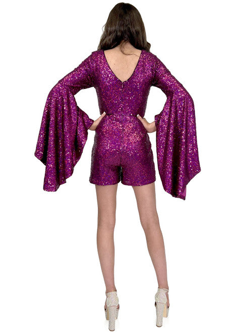 This Marc Defang 8219 Sequin Long Bell Sleeve Pageant Romper is designed with an eye-catching sequin pattern, long bell sleeves and a modern fit. It's the perfect choice for formal events, offering show-stopping style and comfort. contact us for additional colors  Sizes: 00-16  Colors: Lilac, Eggplant, Purple, Blue