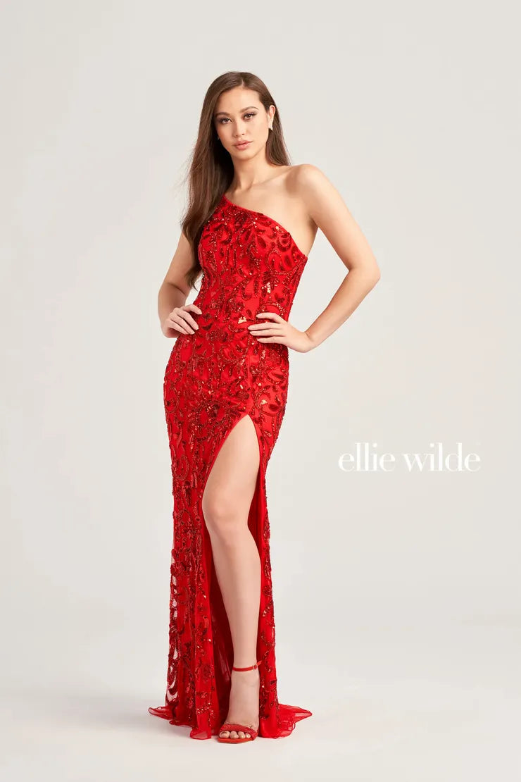 Expertly crafted by Ellie Wilde EW35021, this one shoulder prom dress is sure to make a statement. The intricate beaded and sequin detailing adds just the right amount of sparkle, while the slit provides a touch of elegance. Perfect for any formal occasion, this gown is designed to stand out.  Sizes: 00-16  Colors: Lavender, Red, Royal Blue