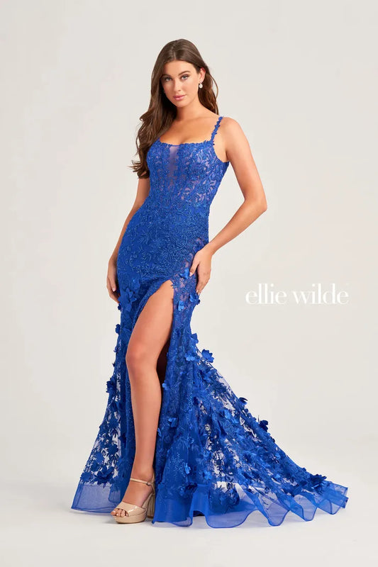 Elevate your prom look with Ellie Wilde EW35053 sheer lace shimmer gown. Featuring a mermaid silhouette, scoop neck, and a daring leg slit, this dress is sure to turn heads. With its intricate lace detailing and shimmering fabric, you'll feel like a princess on your special night. Covered in heat set crystals and beading.  Sizes: 00-16  Colors: Royal Blue, Black, Red