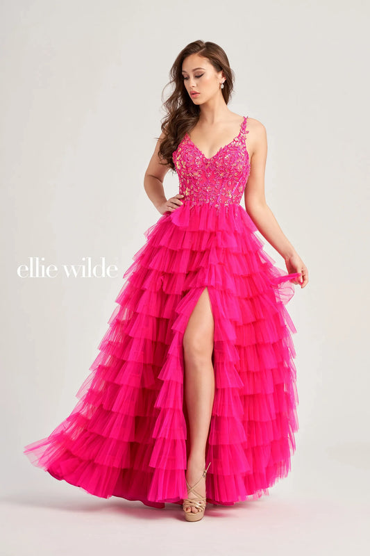 This Ellie Wilde EW35059 prom dress exudes elegance and glamour. The long tulle layers, A-line silhouette, and lace Sequin corset enhance your natural curves, while the maxi slit and sequin details add a touch of sparkle. Perfect for prom or any formal event, this dress is sure to make a statement.  Sizes: 00-20  Colors: ﻿BLACK, MAGENTA, ROYAL BLUE, BARBIE PINK