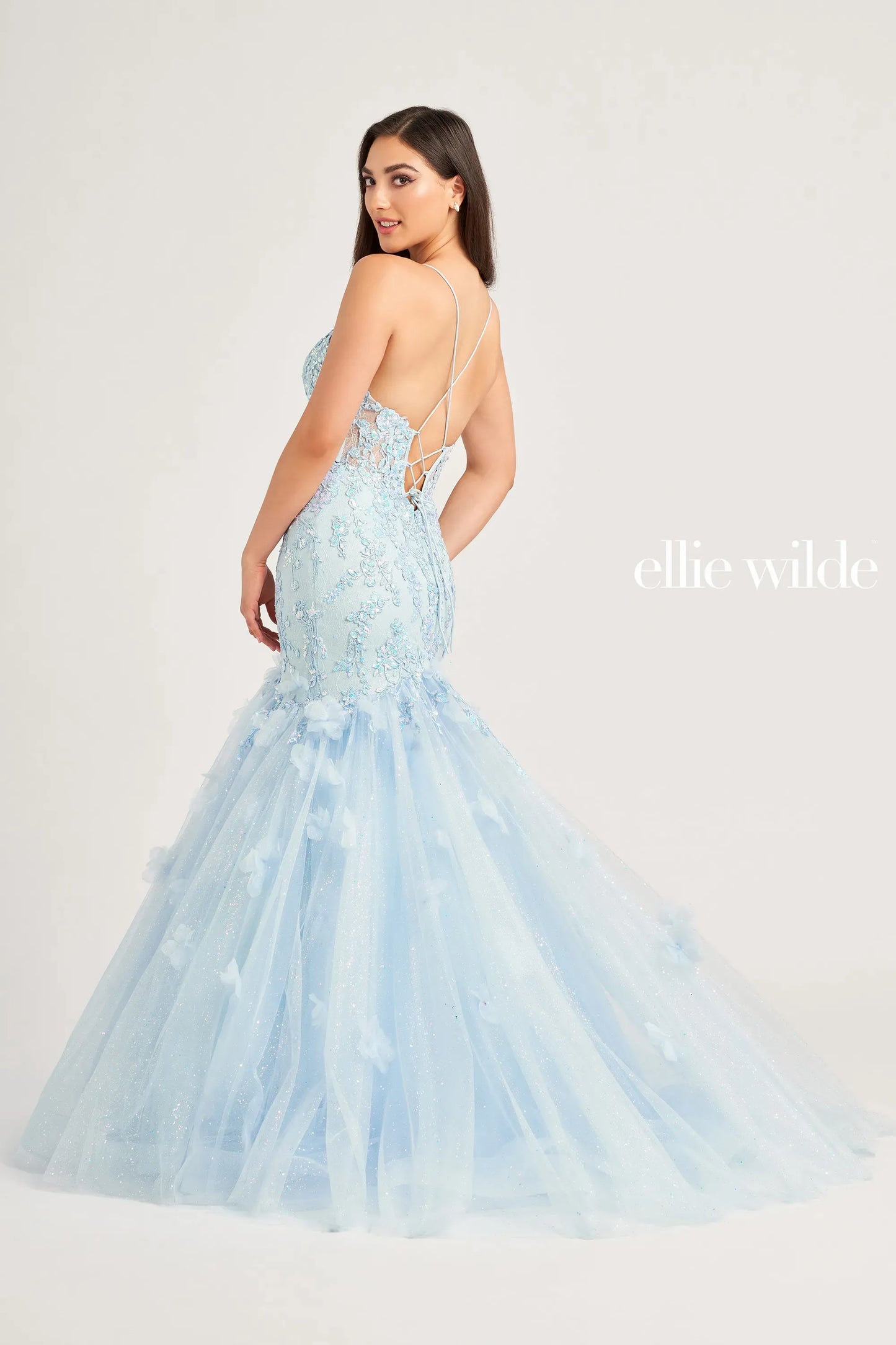 Expertly designed with a sheer lace corset and shimmering sequins, the Ellie Wilde EW35080 Prom Dress exudes elegance and sophistication. The mermaid silhouette accentuates curves, making you feel confident and glamorous. Perfect for prom or any formal occasion, this gown is sure to make a statement.  Sizes: 00-16  Colors: Light Blue, Hot Pink, Orange
