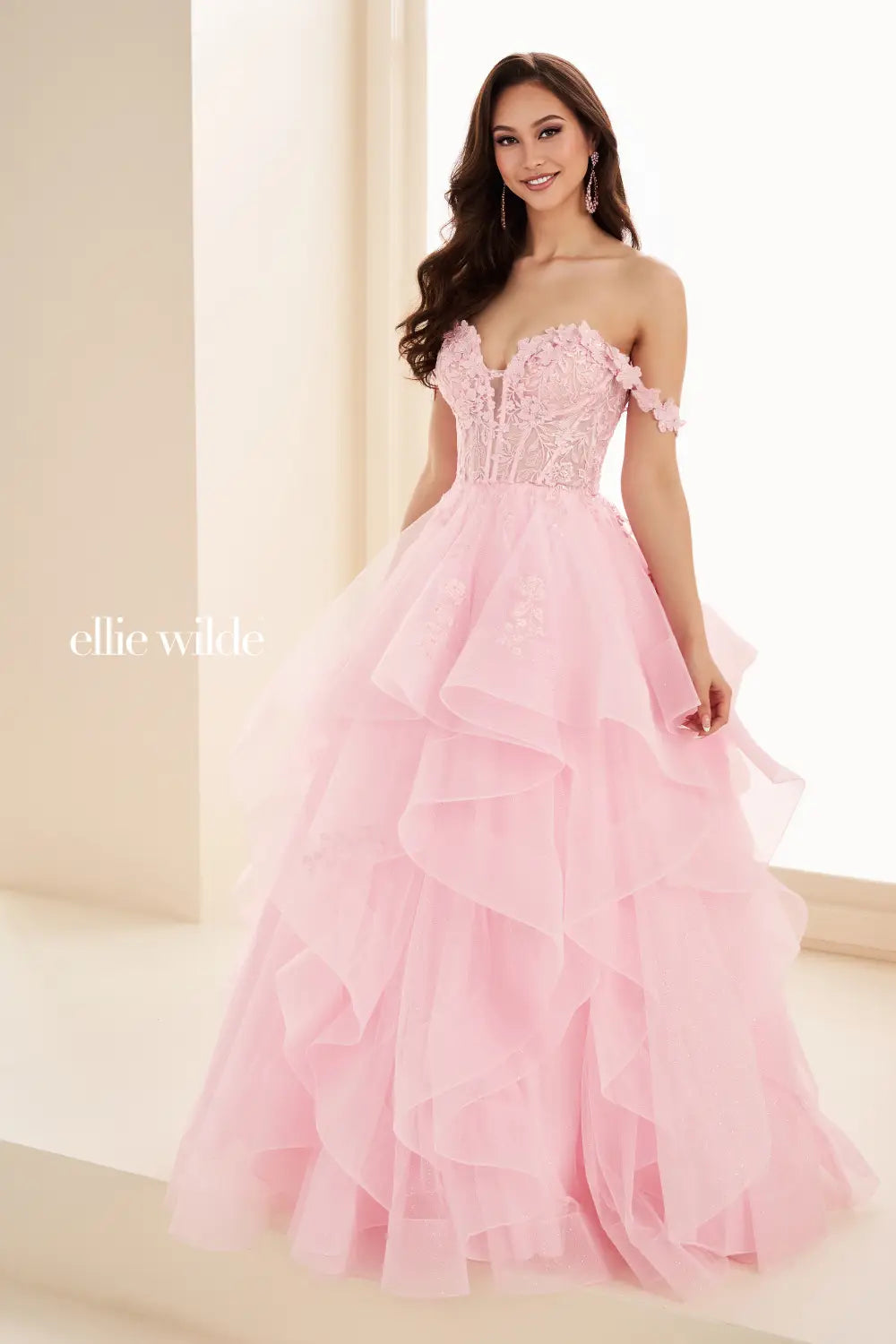 Make a statement in the Ellie Wilde EW35084 prom dress. Featuring an off-the-shoulder top, shimmer sequin lace and ruffle detail, the dress offers a timeless and sophisticated look perfect for the big night. Keep it classic in this classic formal gown.

Sizes: 00-24

Colors: Bluebell, Diamond White, Dusty Rose/Gold, Emerald, Hot Pink, Lavender, Light Pink, Light Yellow, Navy, Red, Royal, Silver, Teal, Wine&nbsp;