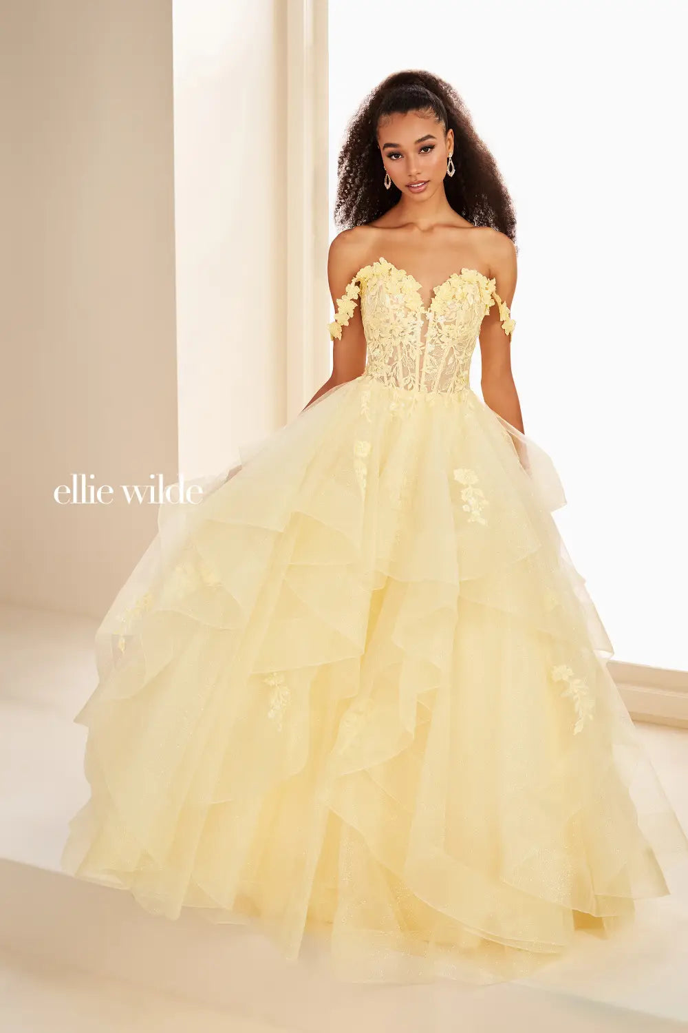 Make a statement in the Ellie Wilde EW35084 prom dress. Featuring an off-the-shoulder top, shimmer sequin lace and ruffle detail, the dress offers a timeless and sophisticated look perfect for the big night. Keep it classic in this classic formal gown.

Sizes: 00-24

Colors: Bluebell, Diamond White, Dusty Rose/Gold, Emerald, Hot Pink, Lavender, Light Pink, Light Yellow, Navy, Red, Royal, Silver, Teal, Wine&nbsp;