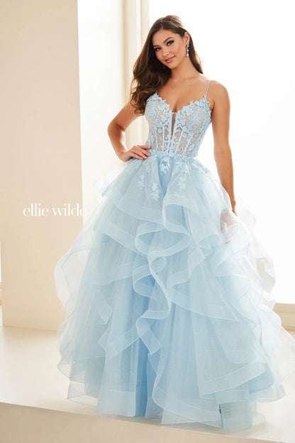 This Ellie Wilde EW36203 prom dress dazzles with a sheer lace corset bodice, ruffle A-line skirt, and shimmering fabric. Create an elegant silhouette with the figure-flattering corset and add a touch of romance with the feminine ruffle detailing. Perfect for a formal evening event, this dress is sure to turn heads.