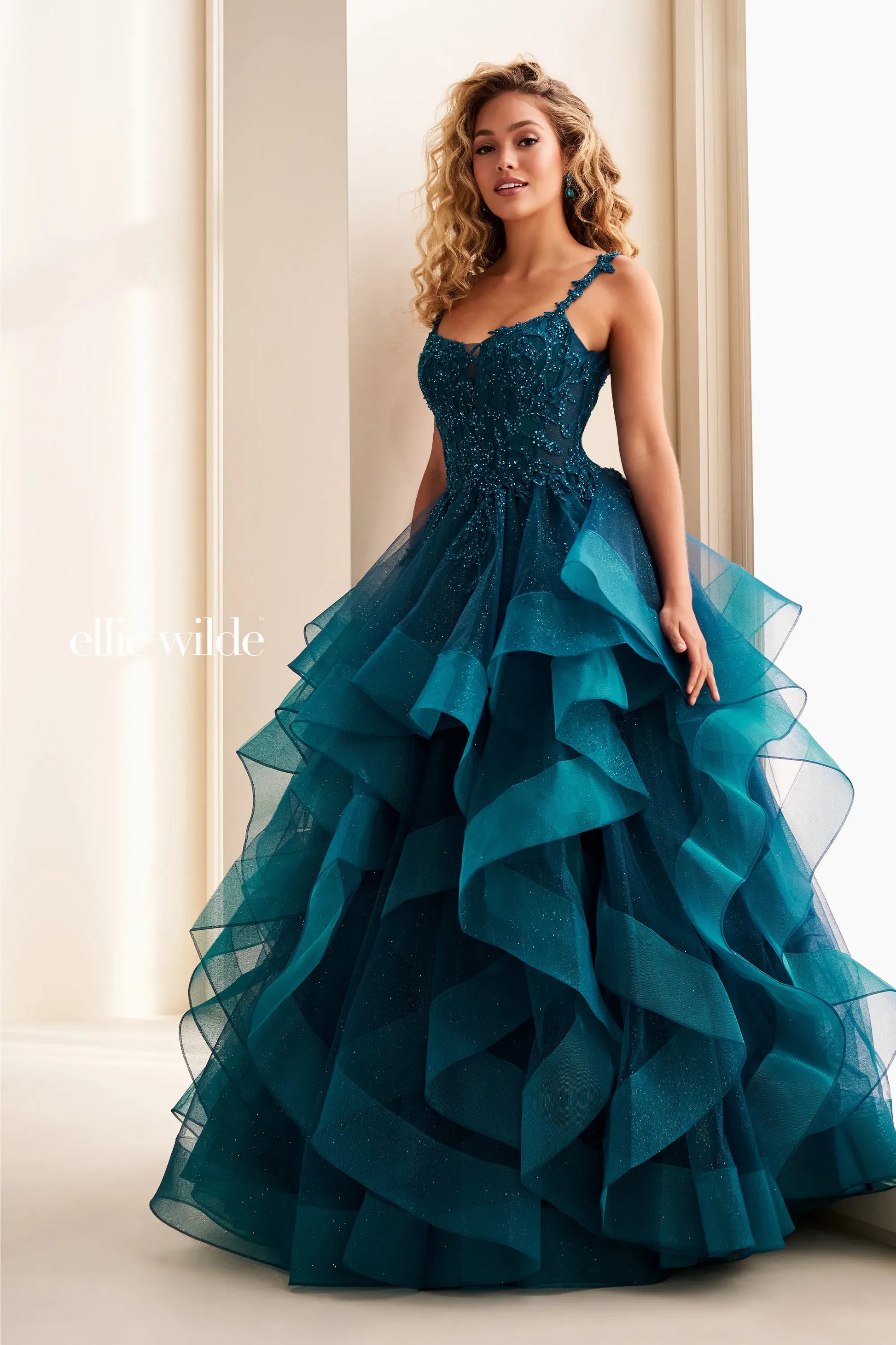 Elevate your prom night with this stunning Ellie Wilde ballgown. The EW37128 features a structured corset bodice and voluminous ruffle skirt in a captivating teal hue. This Size 0 gown combines timeless elegance with dramatic flair, perfect for making an unforgettable entrance. The fitted corset provides support and definition while the cascading ruffles create movement and dimension. Ideal for prom, formal events, or any occasion calling for show-stopping glamour.

Size: 0

Color: Teal