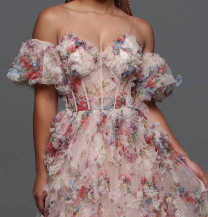 Experience elegance and grace with the Davinci F145 Floral Print Prom Dress. The stunning puff sleeves and A-line silhouette enhance your natural beauty while the sheer corset and shimmering pleats create a dreamy and ethereal look.