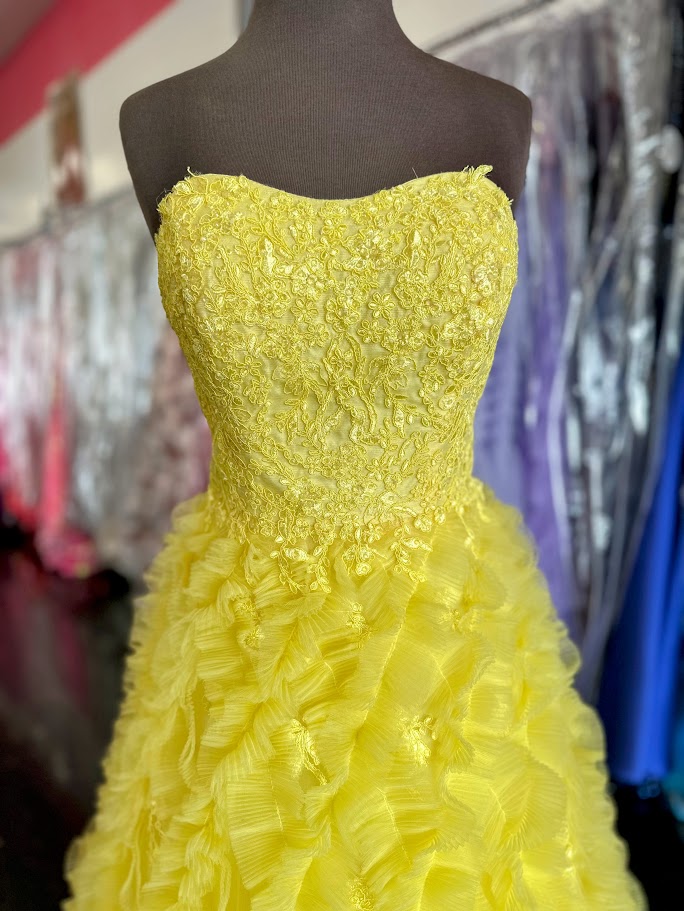 Elevate your formal occasion with this Johnathan Kayne gown, featuring a delicate yellow lace bodice that exudes elegance. The pleated ruffle A-line skirt adds graceful movement, while the cut-out back detail offers a modern, sophisticated touch. Designed in size 4, this ballgown combines classic charm with contemporary style for a stunning, memorable look.

Size: 4

Color: Yellow