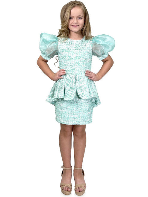 Marc Defang's 5141 short tweed dress offers a stylish and professional look for your daughter's special occasions. This formal dress features and eye-catching puff sleeves and a playful ruffle skirt, while the tweed fabric ensures durability. Perfect for a pageant or an interview, this dress is sure to make a memorable impression.  Sizes: 4-14  Colors: Lemon, Mint, Blush, Light Blue