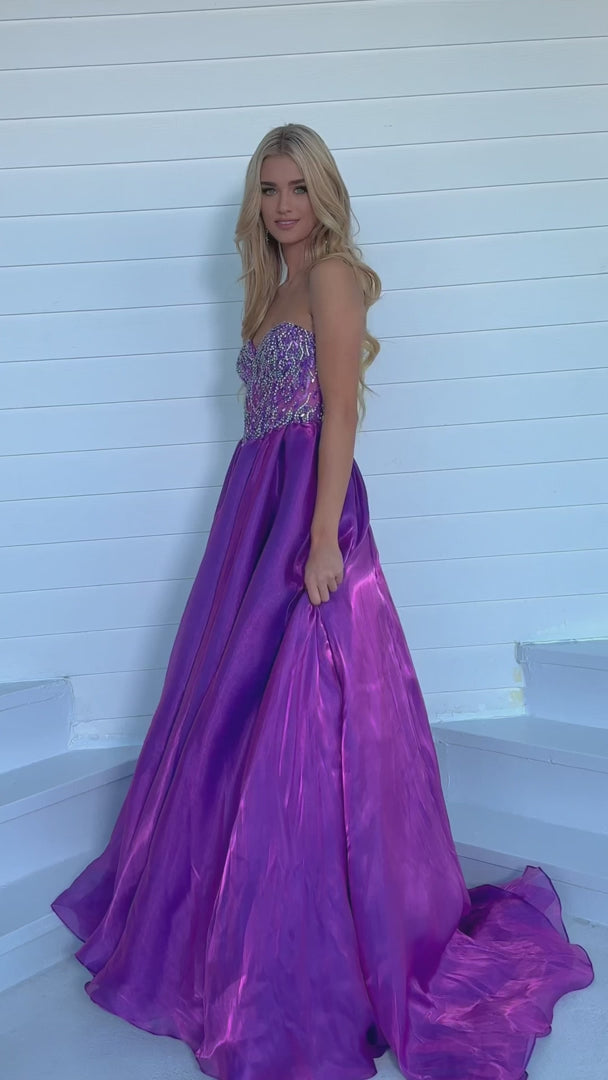 Expertly crafted by Ava Presley, the 28588 Long Prom Dress boasts a strapless, open back design that accentuates the A-line ballgown silhouette. The crystal bodice adds a touch of glamour, making it the perfect choice for a formal event or pageant. Show off your elegant style with this stunning dress.