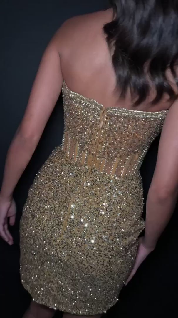 Elevate your evening with the Ashley Lauren 4564 cocktail dress, featuring intricate sequin beading that catches the light with every movement. This short homecoming gown combines a structured corset silhouette with sheer detailing for a refined and alluring look. Perfect for special occasions, it offers a sophisticated blend of glamour and elegance to make a memorable statement.&nbsp;Ashley Lauren 4564&nbsp;Strapless cocktail dress beaded with exposed boning. The wrap sequin skirt completes the look.

Stra